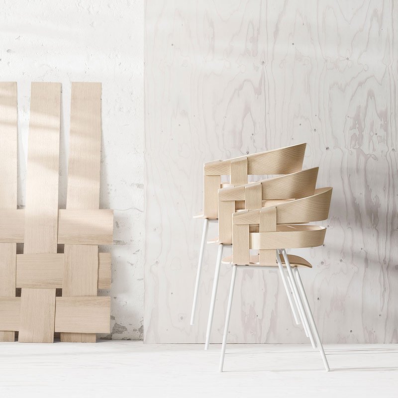 Woodmart theme demo photo of stacked chairs against a concrete wall